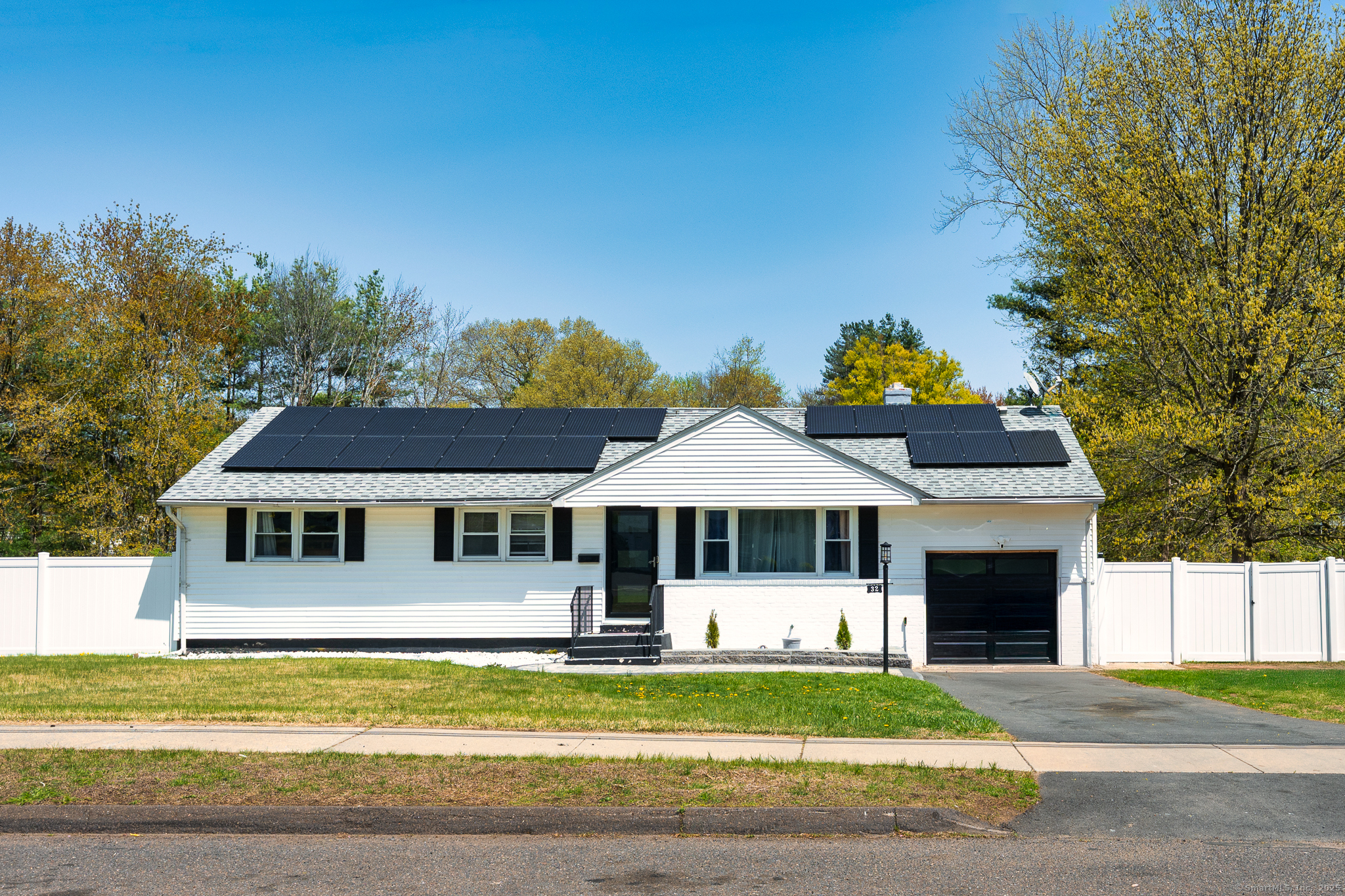 32 Custer Drive Windsor, CT 06095 - Photo 1 of 1 a front view of a house with a yard table and chairs