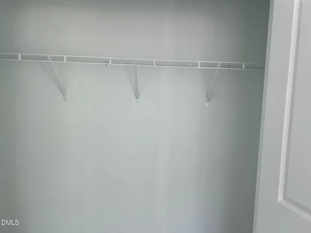 a white toilet sitting next to a white sink and vanity