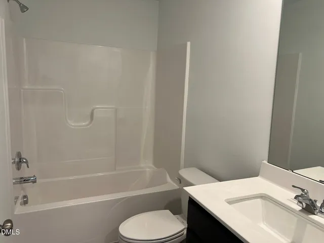 a kitchen with kitchen island granite countertop a sink cabinets and stainless steel appliances