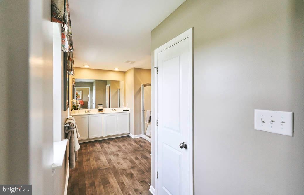 62 Buttercup Circle Elkton, MD 21921 - Photo 24 of 36 a view of a hallway with wooden floor and kitchen