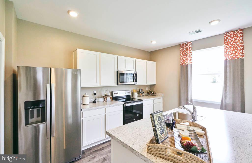 62 Buttercup Circle Elkton, MD 21921 - Photo 7 of 36 a kitchen with stainless steel appliances granite countertop a refrigerator sink stove microwave and cabinets
