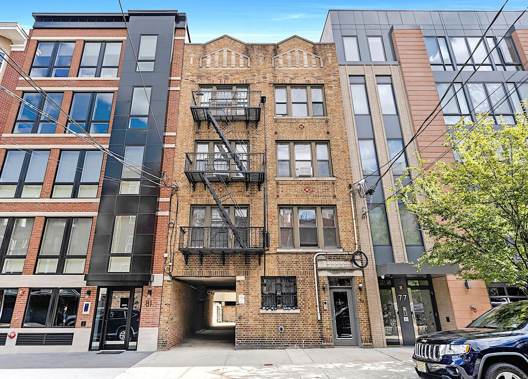 79 Madison Street, Unit 4A Hoboken, NJ 07030 - Photo 1 of 17 a front view of a residential apartment building with a yard