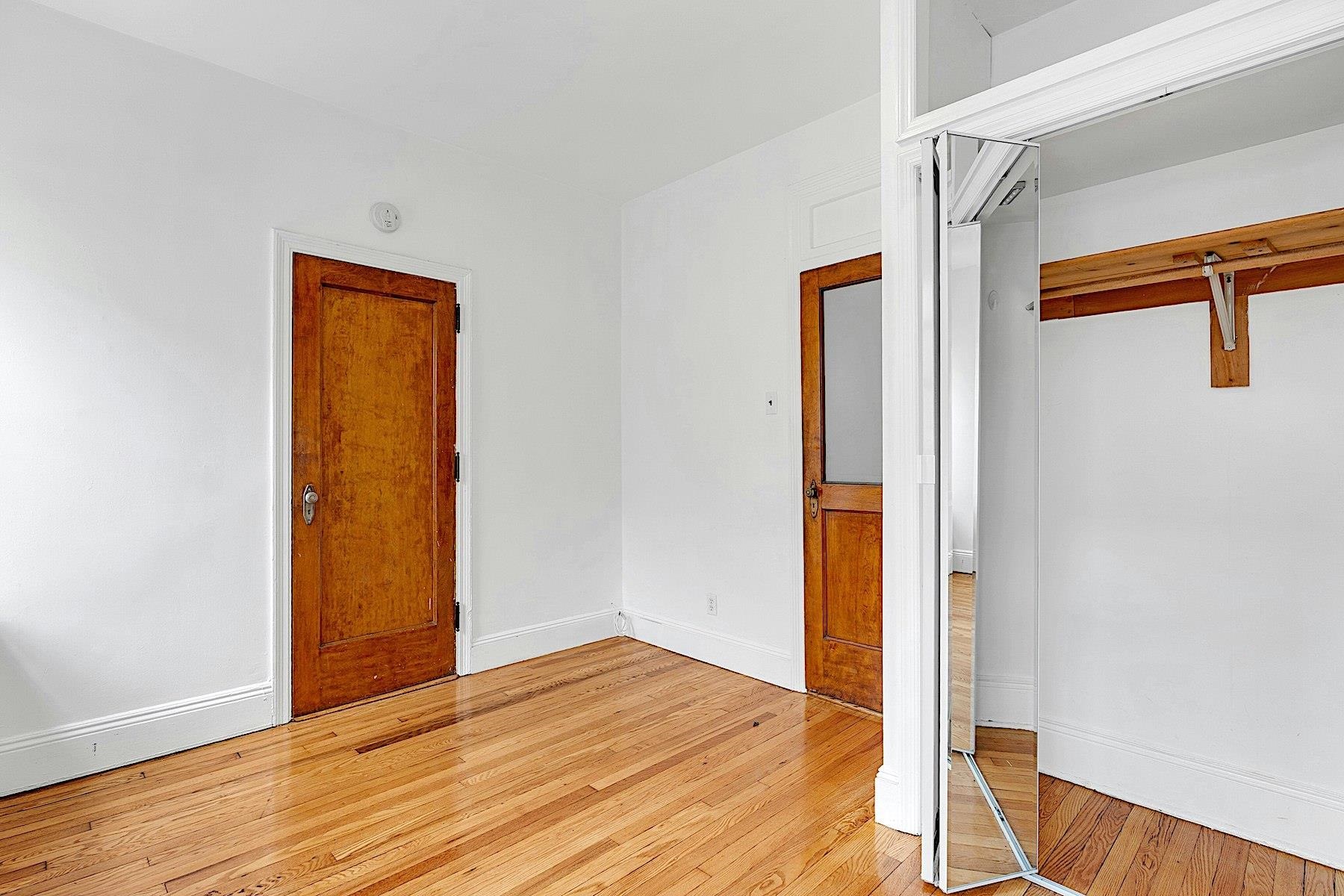 79 Madison Street, Unit 4A Hoboken, NJ 07030 - Photo 12 of 17 a view of empty room with wooden floor