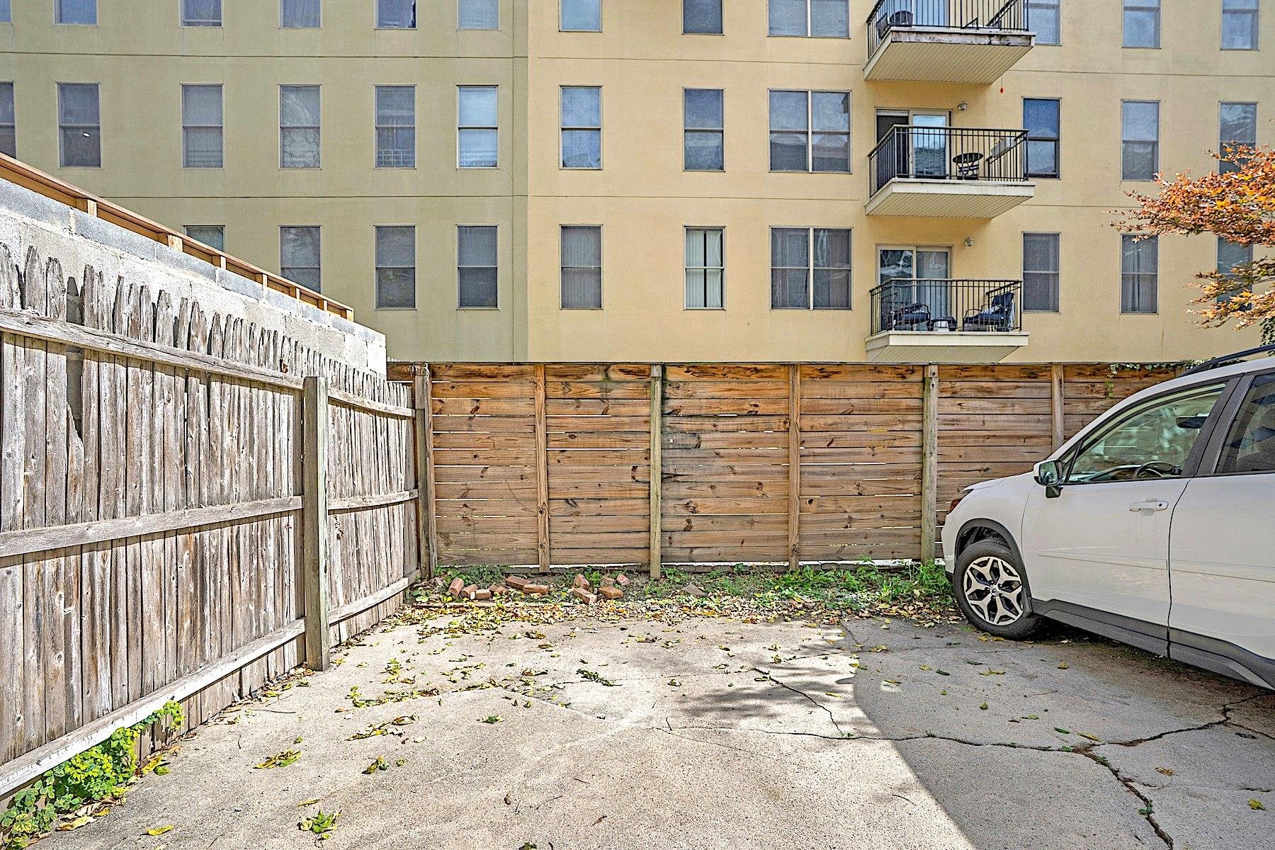 79 Madison Street, Unit 4A Hoboken, NJ 07030 - Photo 16 of 17 a view of a blue house with a parking space in back yard