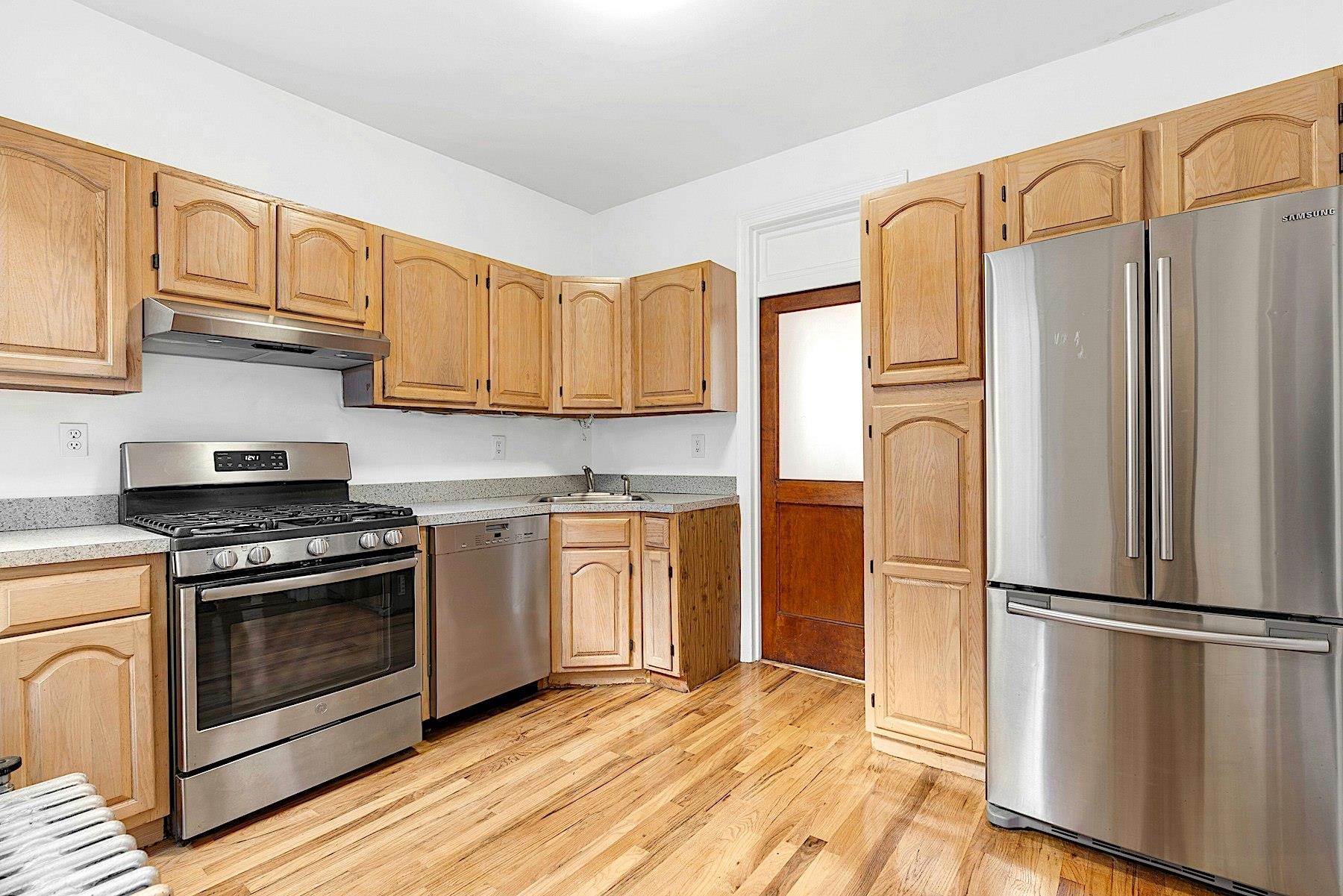 79 Madison Street, Unit 4A Hoboken, NJ 07030 - Photo 3 of 17 a kitchen with a refrigerator sink and cabinets