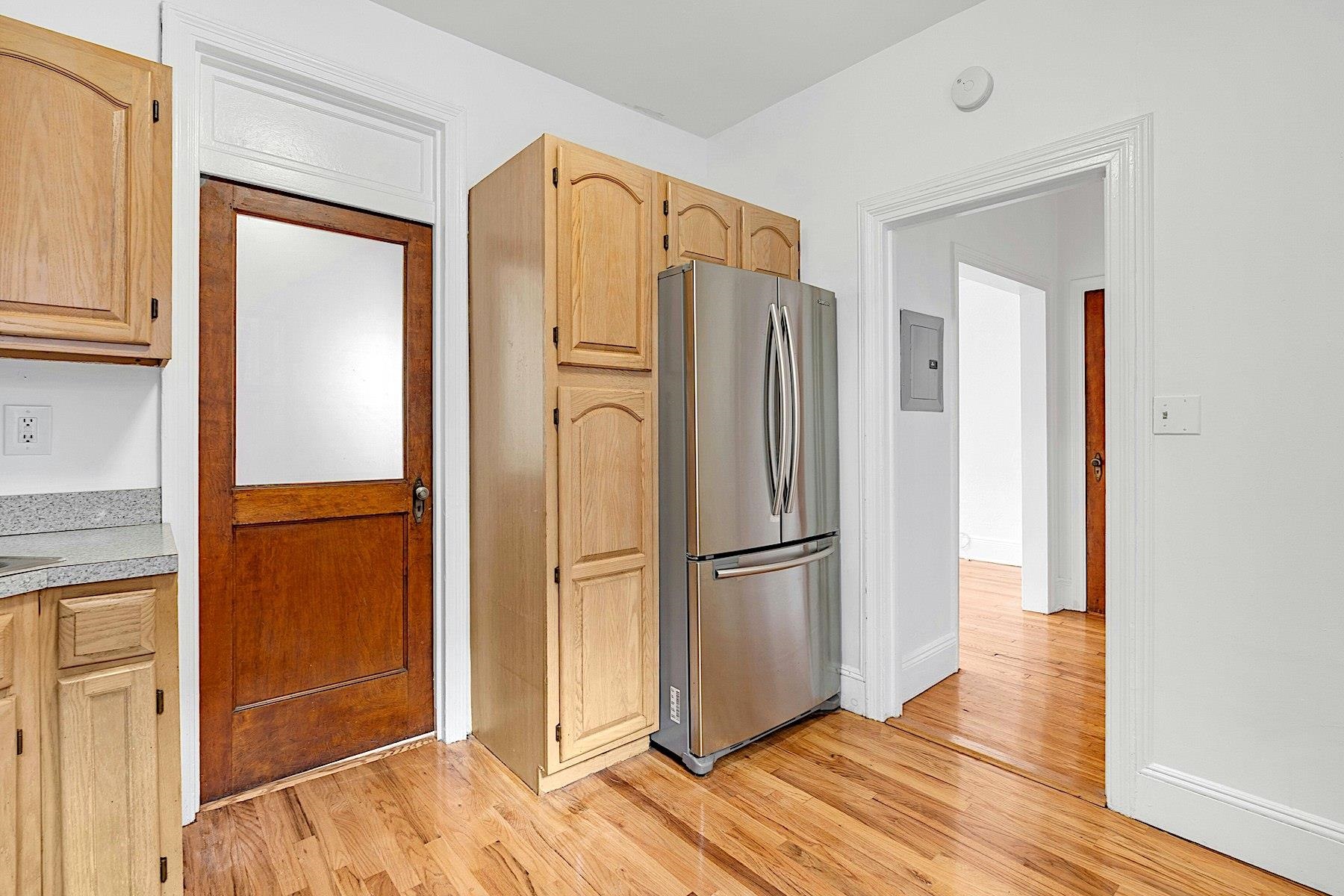 79 Madison Street, Unit 4A Hoboken, NJ 07030 - Photo 4 of 17 a view of kitchen with wooden floor refrigerator and cabinet