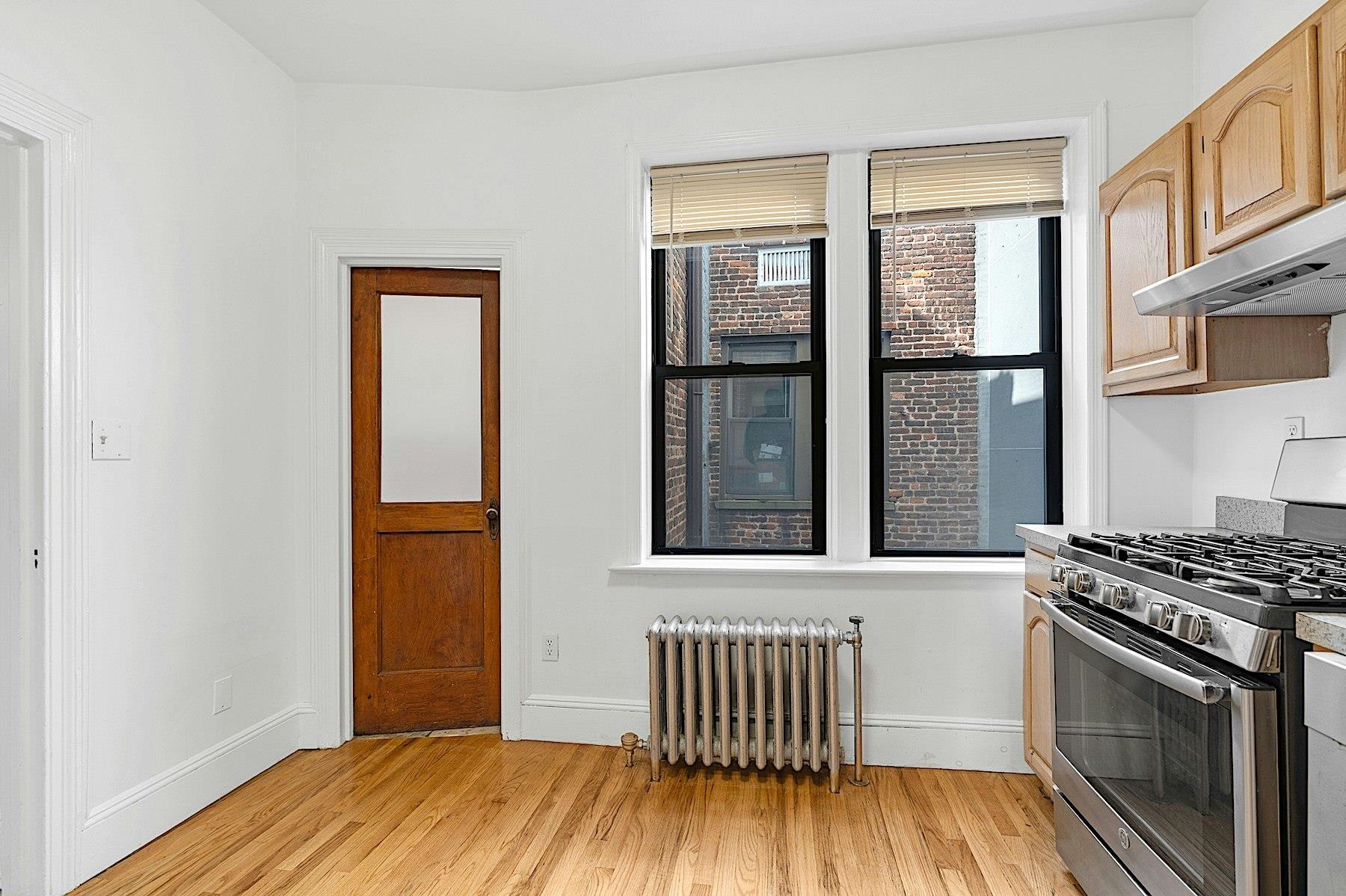 79 Madison Street, Unit 4A Hoboken, NJ 07030 - Photo 5 of 17 a kitchen with wooden floor and a window