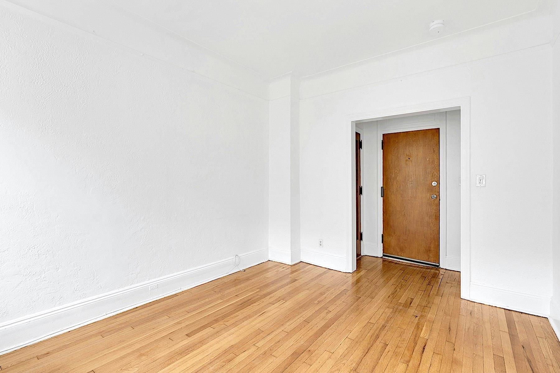 79 Madison Street, Unit 4A Hoboken, NJ 07030 - Photo 8 of 17 a view of an empty room with wooden floor and closet