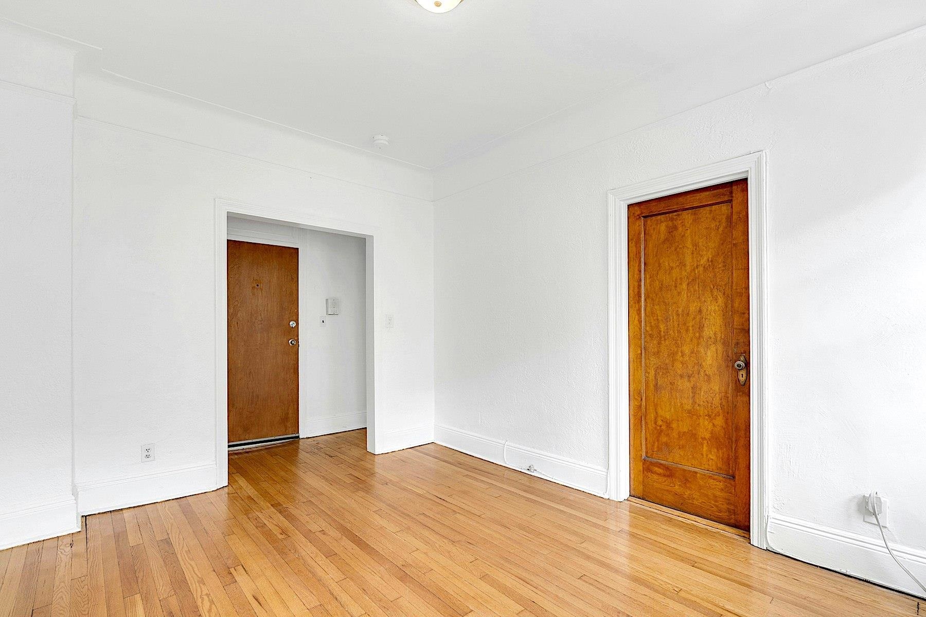 79 Madison Street, Unit 4A Hoboken, NJ 07030 - Photo 9 of 17 an empty room with wooden floor and closet