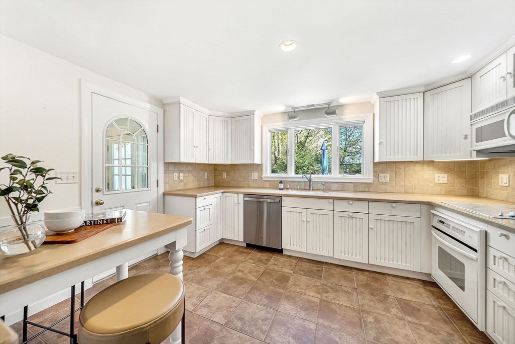 10 Bennett Road Wayland, MA 01778 - Photo 13 of 32 a kitchen with a sink cabinets and window