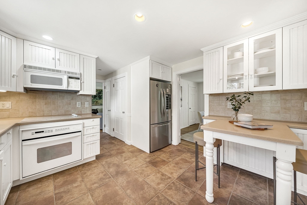 10 Bennett Road Wayland, MA 01778 - Photo 15 of 32 a kitchen with a stove a sink and a refrigerator