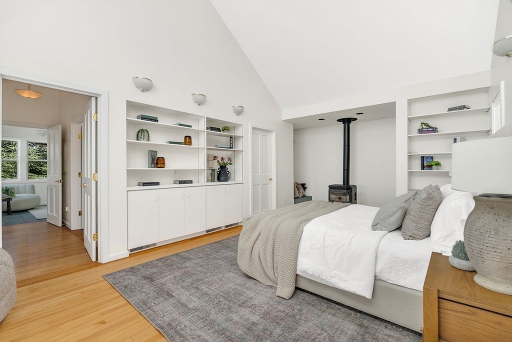 10 Bennett Road Wayland, MA 01778 - Photo 19 of 32 a bedroom with a bed and walk in closet with wooden floor