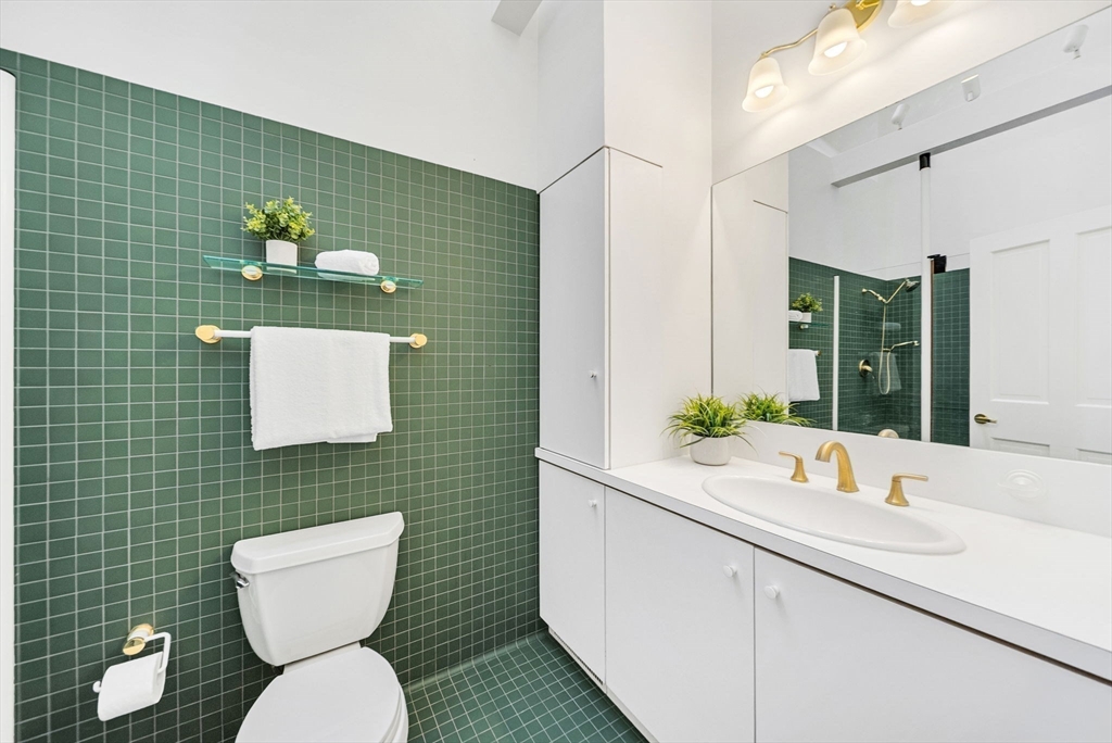 10 Bennett Road Wayland, MA 01778 - Photo 20 of 32 a bathroom with a toilet sink and mirror