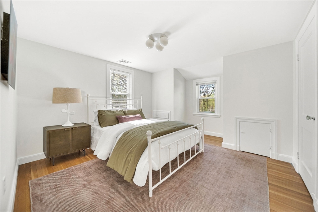 10 Bennett Road Wayland, MA 01778 - Photo 25 of 32 a spacious bedroom with a bed and a couch