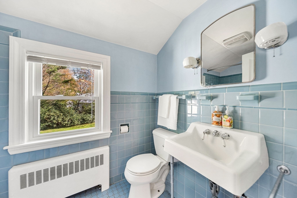 10 Bennett Road Wayland, MA 01778 - Photo 30 of 32 a bathroom with a sink a toilet and a mirror