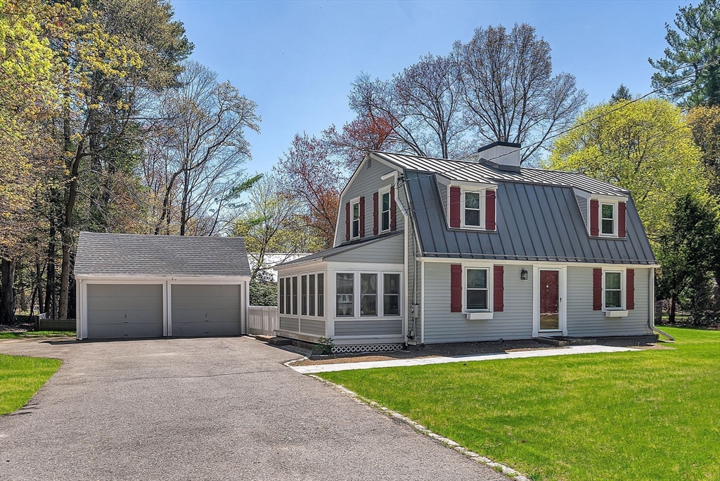 10 Bennett Road Wayland, MA 01778 - Photo 3 of 32 a front view of a house with a garden and yard