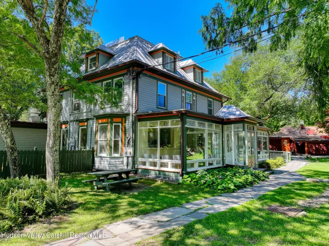 a view of a lush green forest with a mountain
