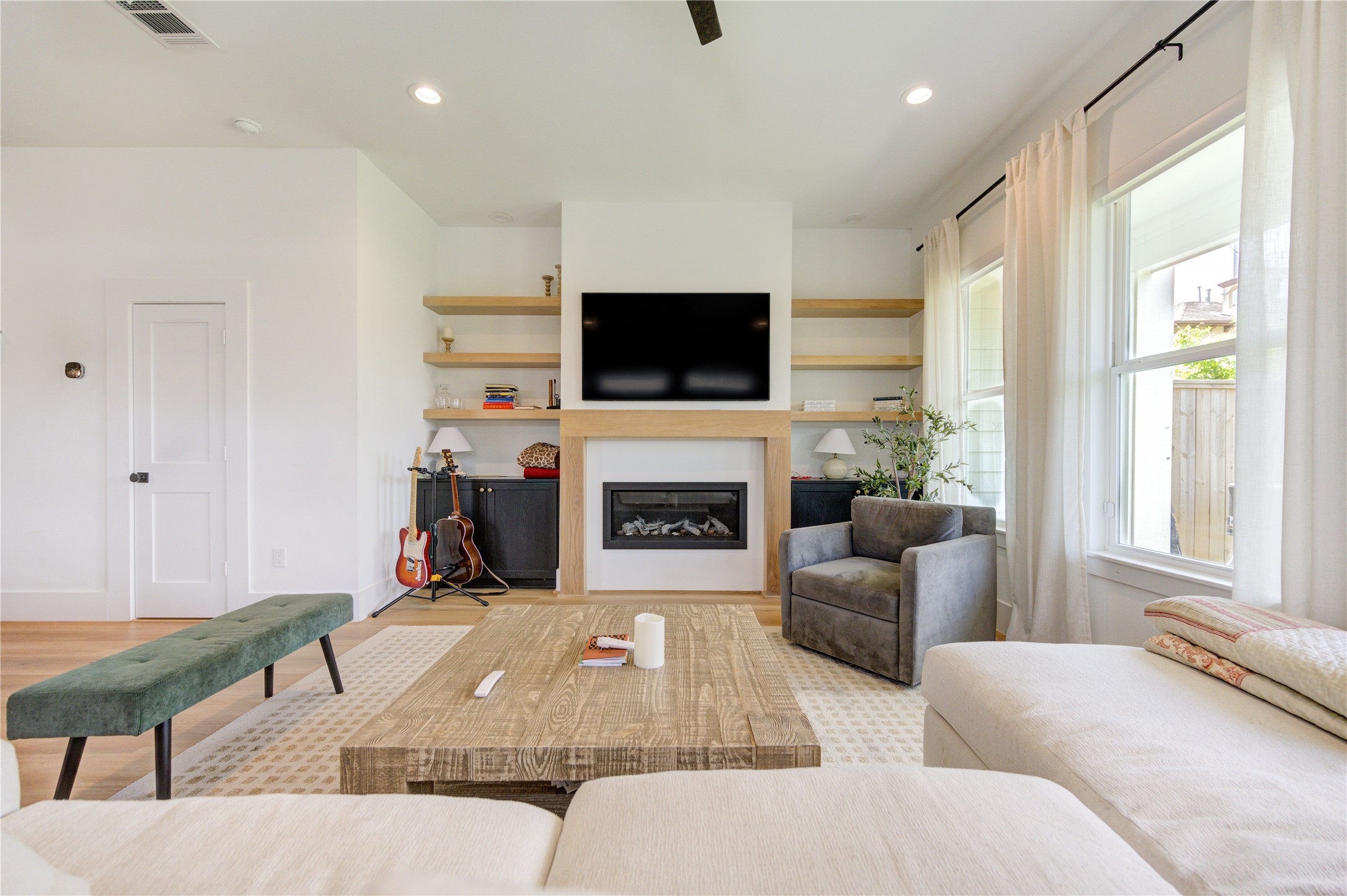 18 Sidney Street, Unit A Houston, TX 77003 - Photo 6 of 30 a living room with furniture a flat screen tv and a fireplace