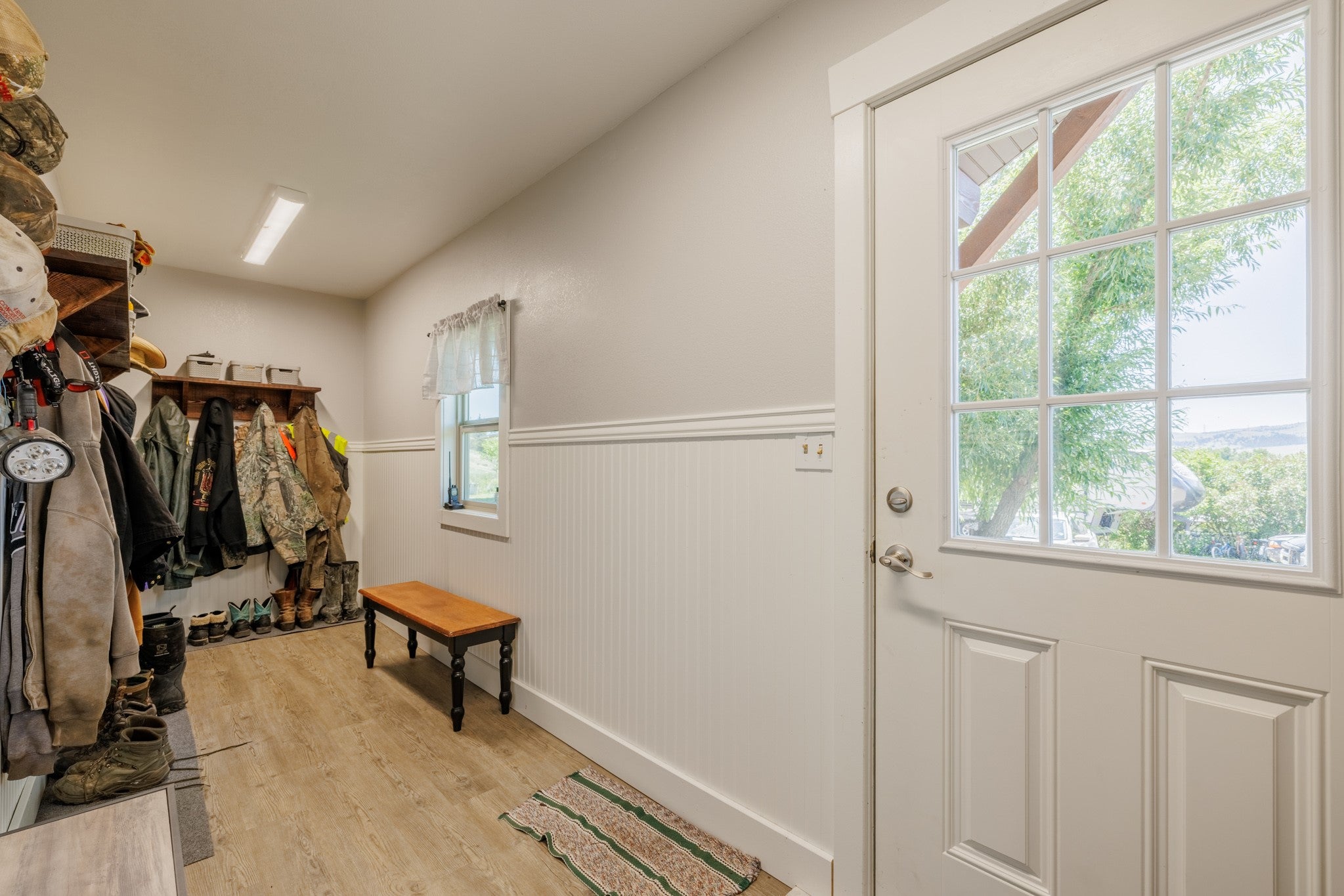 58 Gilman Road Garrison, MT 59731 - Photo 22 of 91 Entryway featuring a wainscoted wall, light wood-style flooring, and healthy amount of natural light