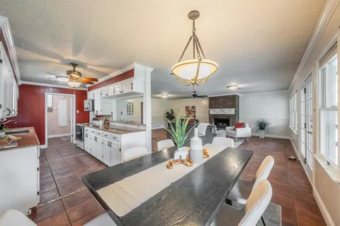 a living room with furniture chandelier and a table