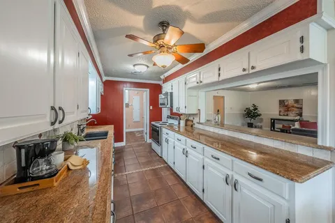 a large living room with stainless steel appliances granite countertop lots of counter top space