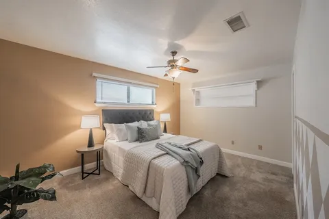 a bedroom with a bed and a lamp