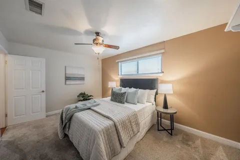 a bedroom with a bed and a chandelier