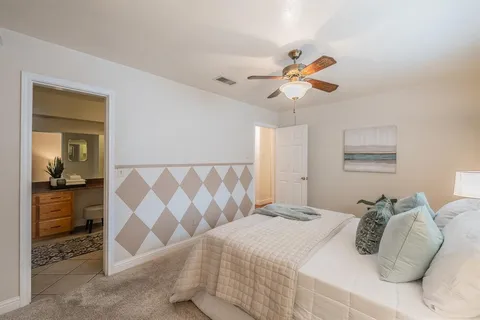 a bedroom with a bed and a chandelier