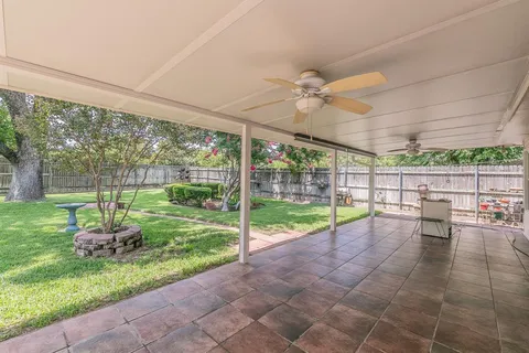 a view of a backyard with a garden and chairs