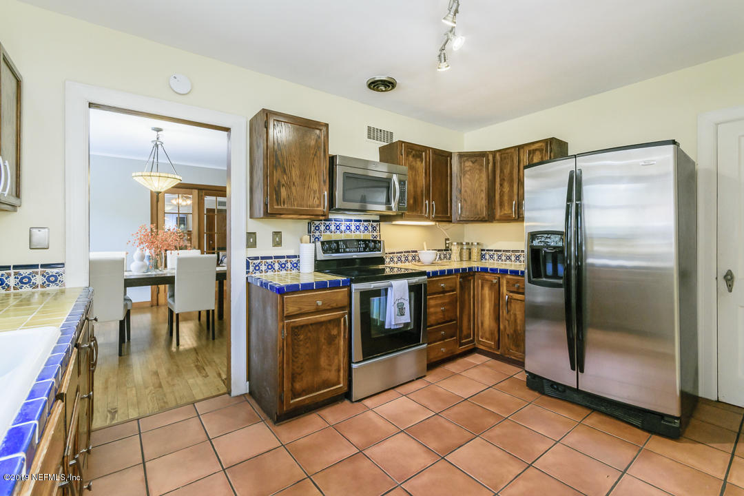 1816 Lorimier Road Jacksonville, FL 32207 - Photo 6 of 25 a kitchen with stainless steel appliances granite countertop a refrigerator a stove a sink and dishwasher