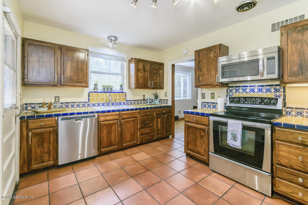 1816 Lorimier Road Jacksonville, FL 32207 - Photo 7 of 25 a kitchen with stainless steel appliances granite countertop a stove a sink and a refrigerator