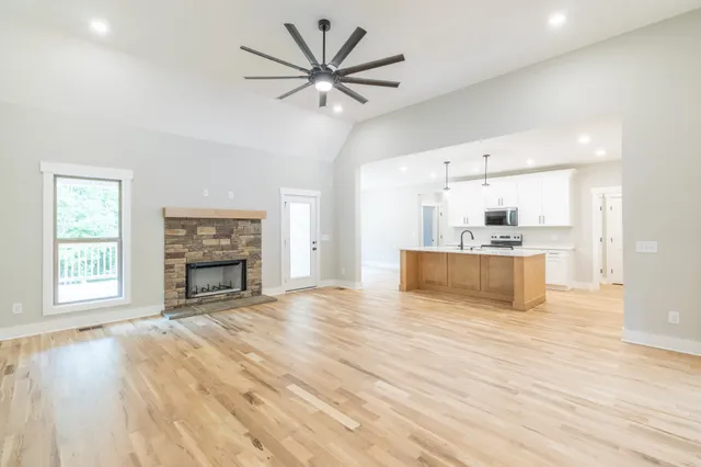 a view of empty room with wooden floor and fireplace