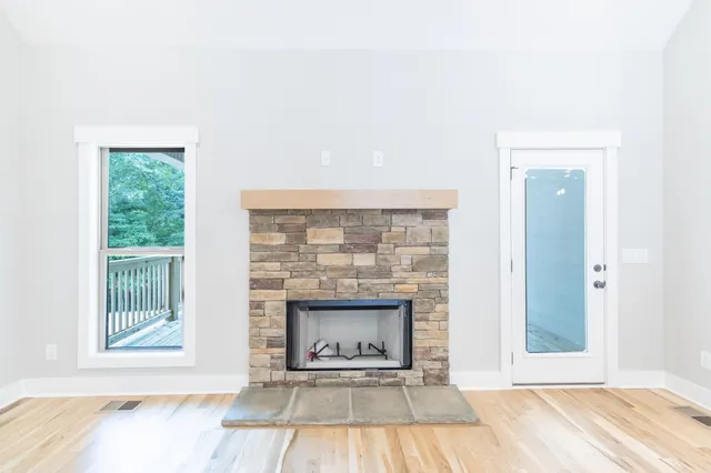 a living room with a fireplace and a floor to ceiling window
