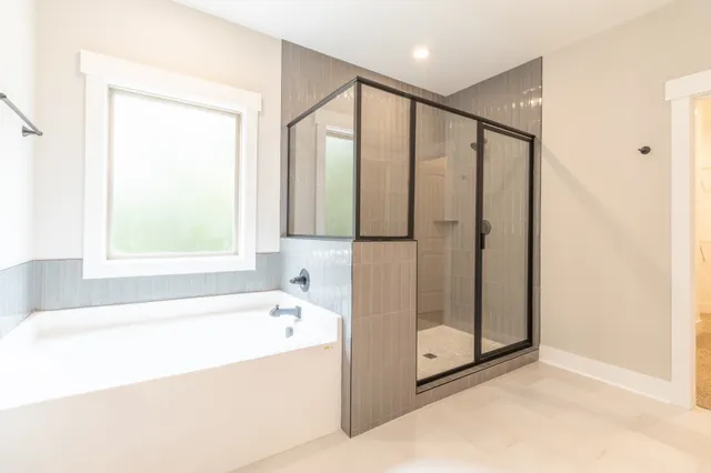 a bathroom with a bathtub and a shower