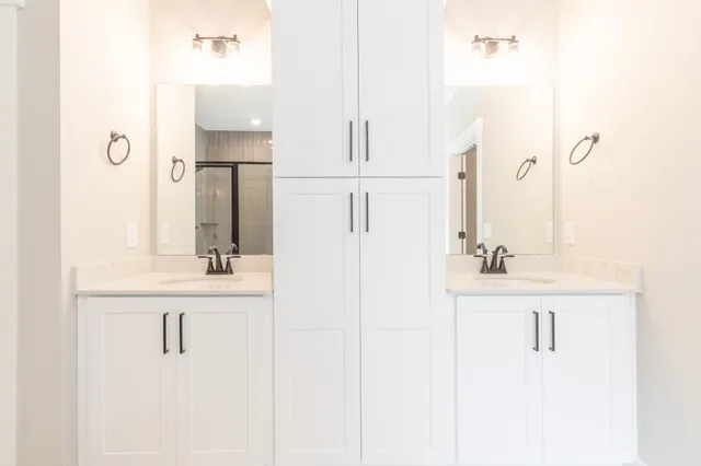 a bathroom with a sink vanity and mirror