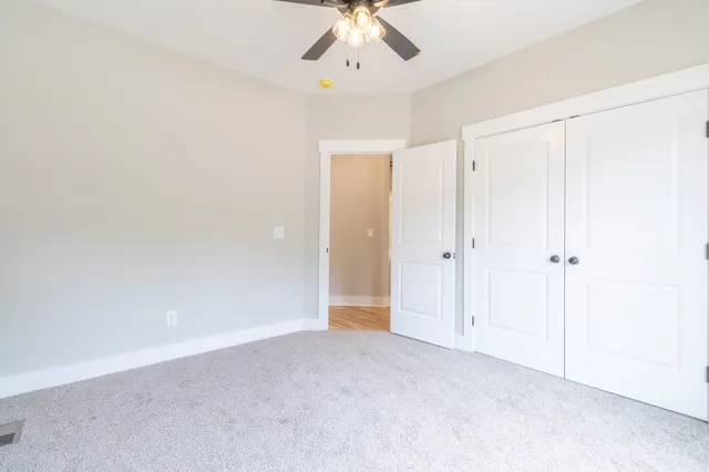 a bathroom with a granite countertop sink a toilet and a mirror