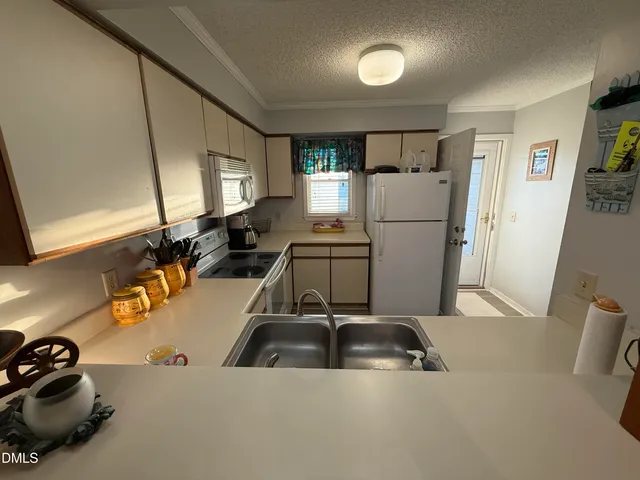 a kitchen that has a sink and a refrigerator