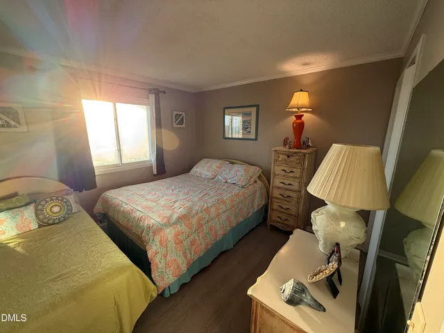 a bedroom with two beds and a lamp