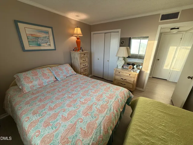 a bedroom with bed and window