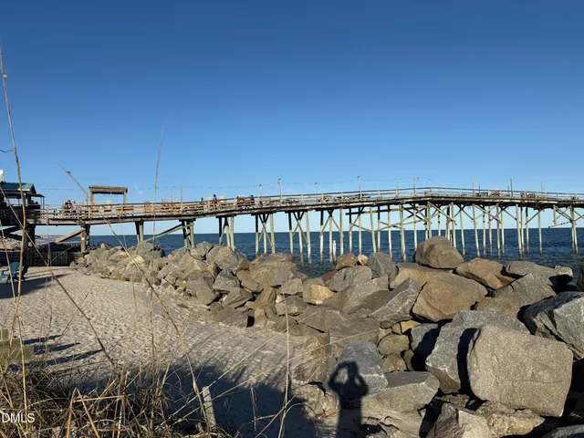 a view of a balcony with chairs and wooden floor