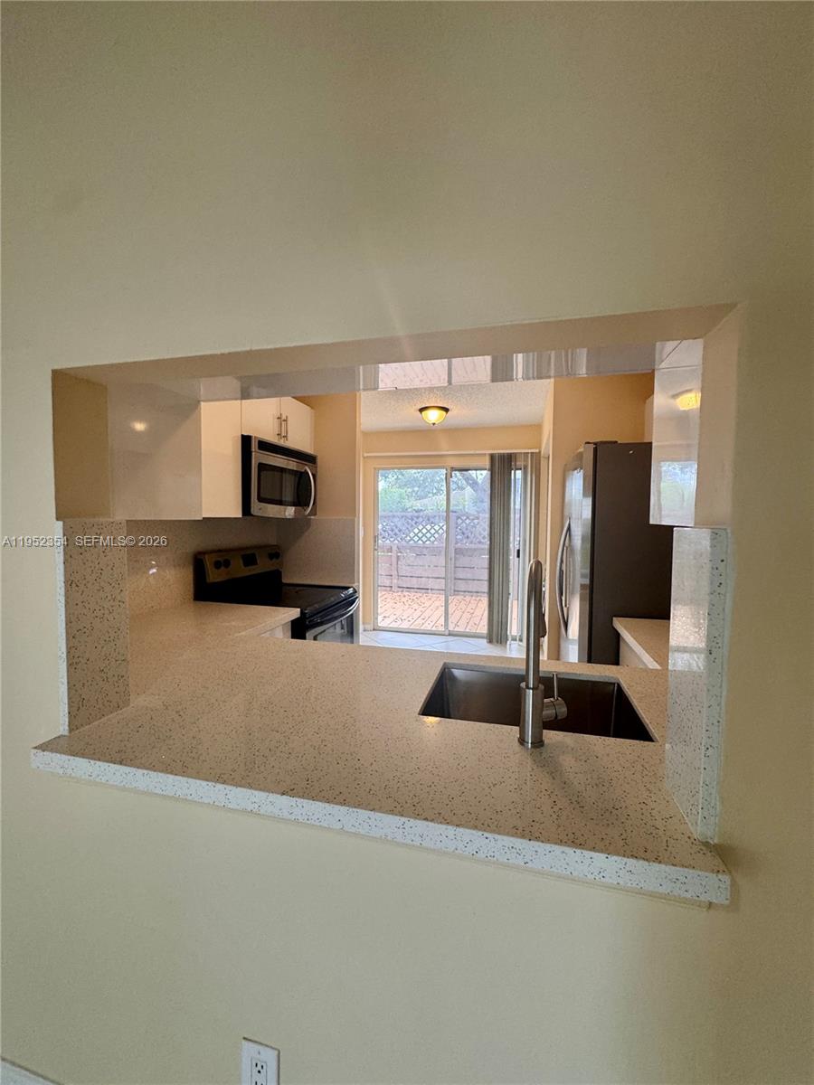 4879 North Hemingway Circle Margate, FL 33063 - Photo 12 of 44 a living room with furniture and a large window
