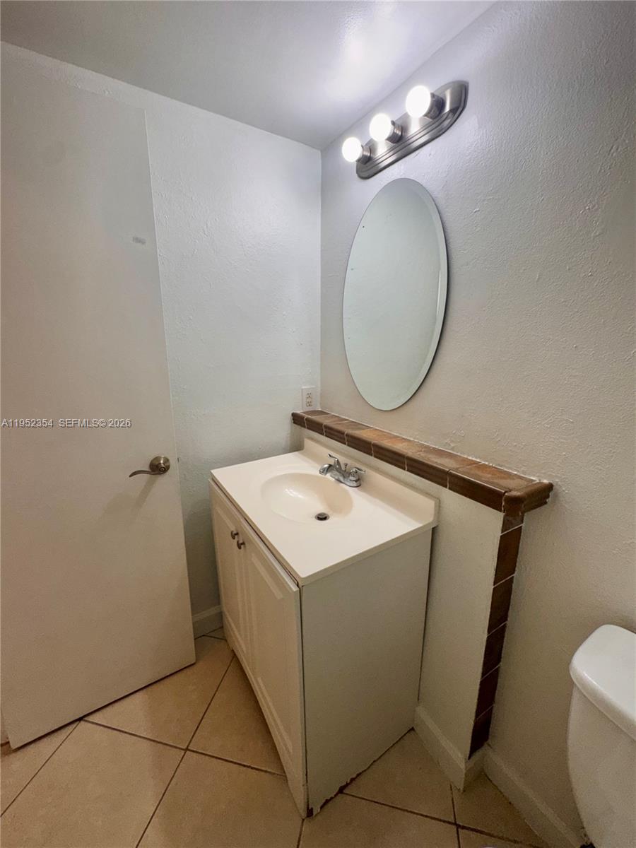 4879 North Hemingway Circle Margate, FL 33063 - Photo 14 of 44 a bathroom with a sink mirror vanity and toilet