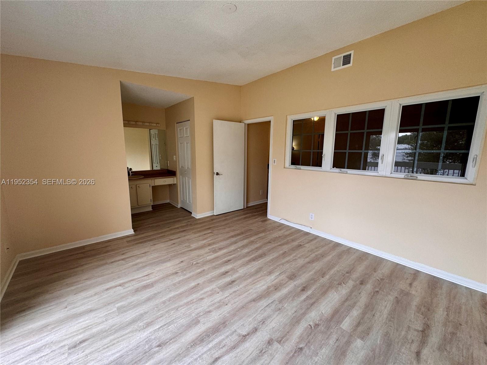 4879 North Hemingway Circle Margate, FL 33063 - Photo 22 of 44 a view of an empty room with wooden floor and a window