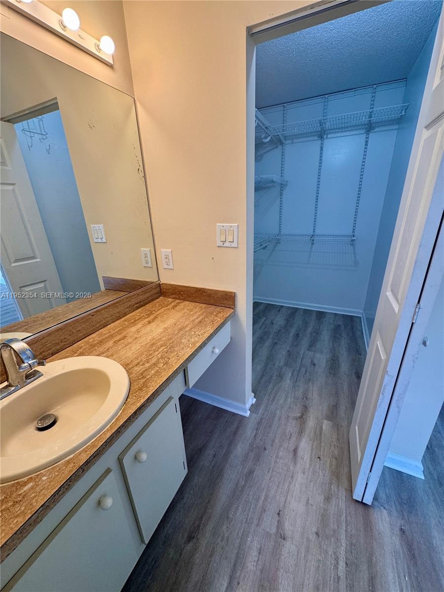 4879 North Hemingway Circle Margate, FL 33063 - Photo 24 of 44 a bathroom with a granite countertop sink and a mirror