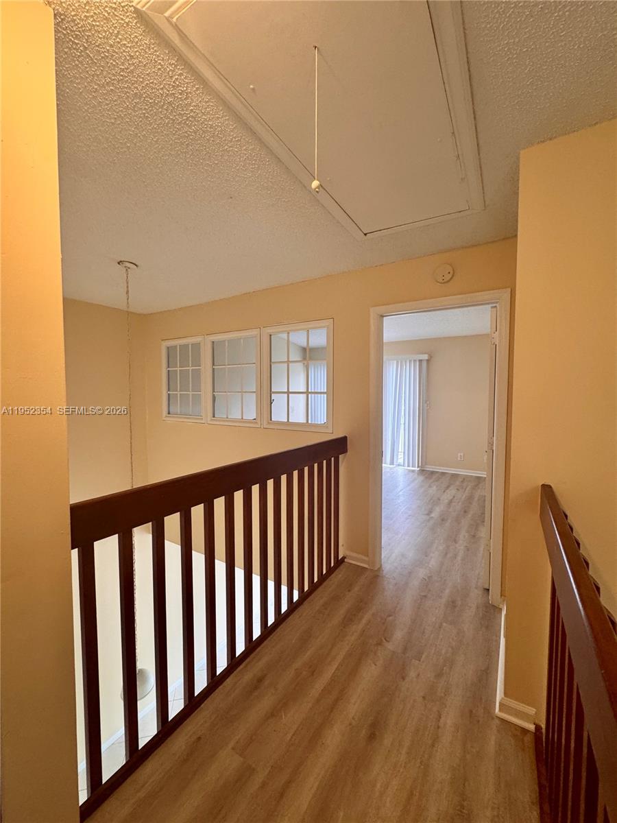 4879 North Hemingway Circle Margate, FL 33063 - Photo 28 of 44 a view of a hallway with wooden floor