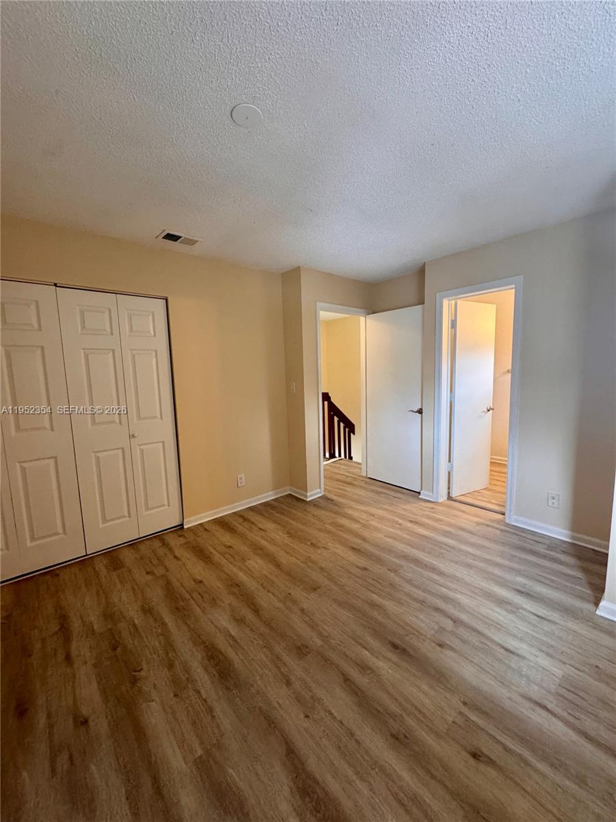 4879 North Hemingway Circle Margate, FL 33063 - Photo 30 of 44 a view of empty room with wooden floor and fan