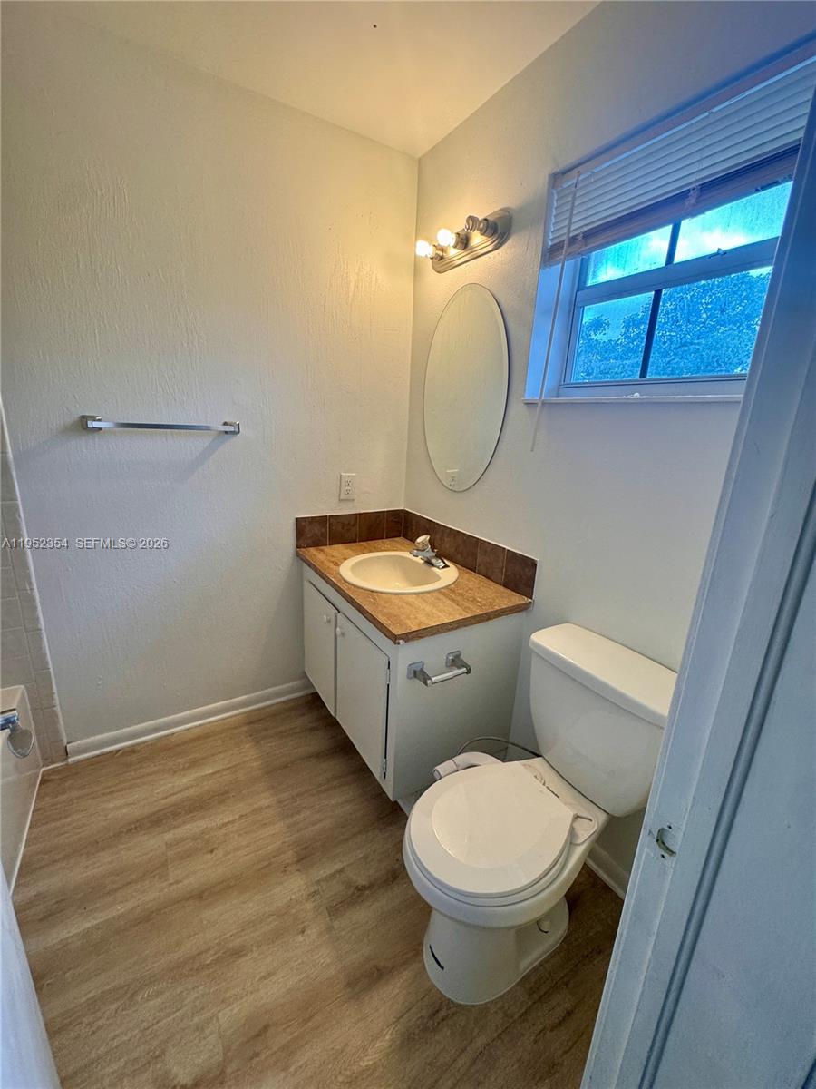 4879 North Hemingway Circle Margate, FL 33063 - Photo 31 of 44 a bathroom with a toilet a sink and a mirror