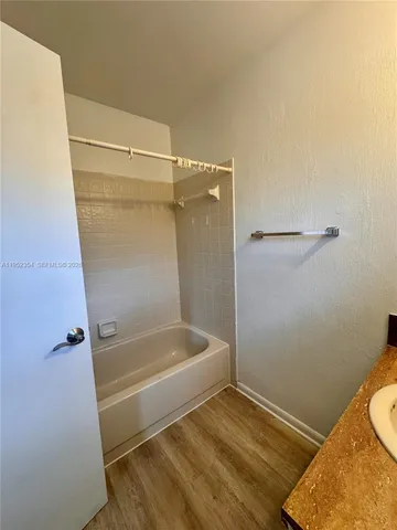 a bathroom with a tub and shower