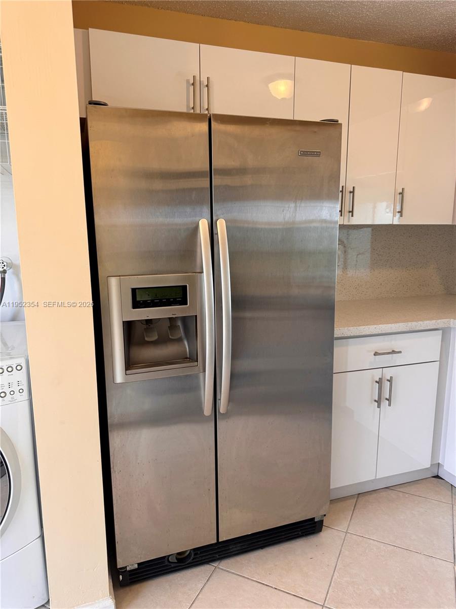 4879 North Hemingway Circle Margate, FL 33063 - Photo 9 of 44 a metallic refrigerator freezer sitting inside of a kitchen