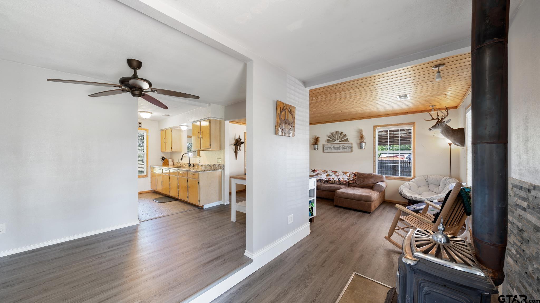29080 Highway 19 Athens, TX 75752 - Photo 4 of 30 a view of a livingroom with furniture hardwood floor a ceiling fan and windows